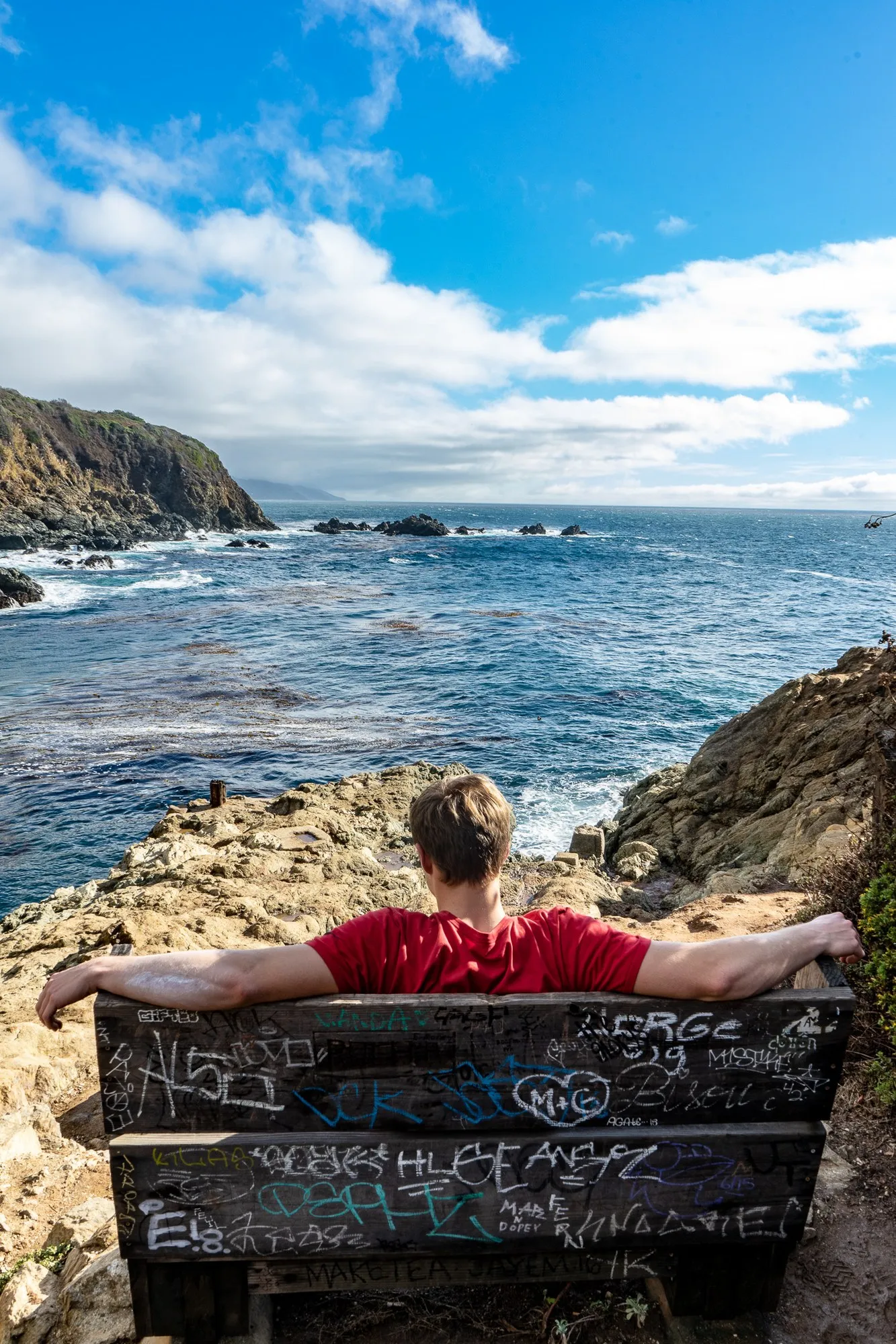Sitting on a bench overlooking the Pacific coast at Big Sur