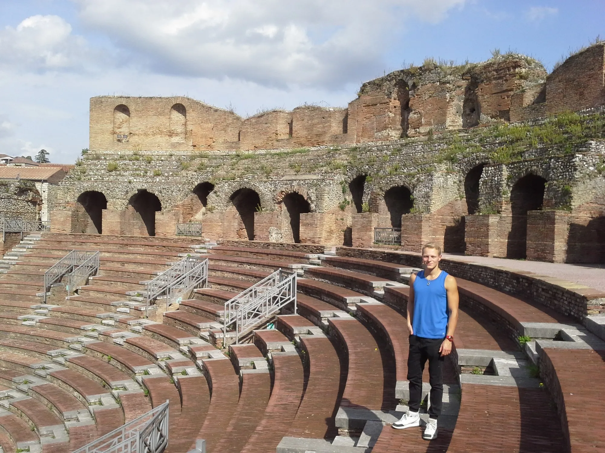 Standing among the stone seats of an amphitheatre in Italy
