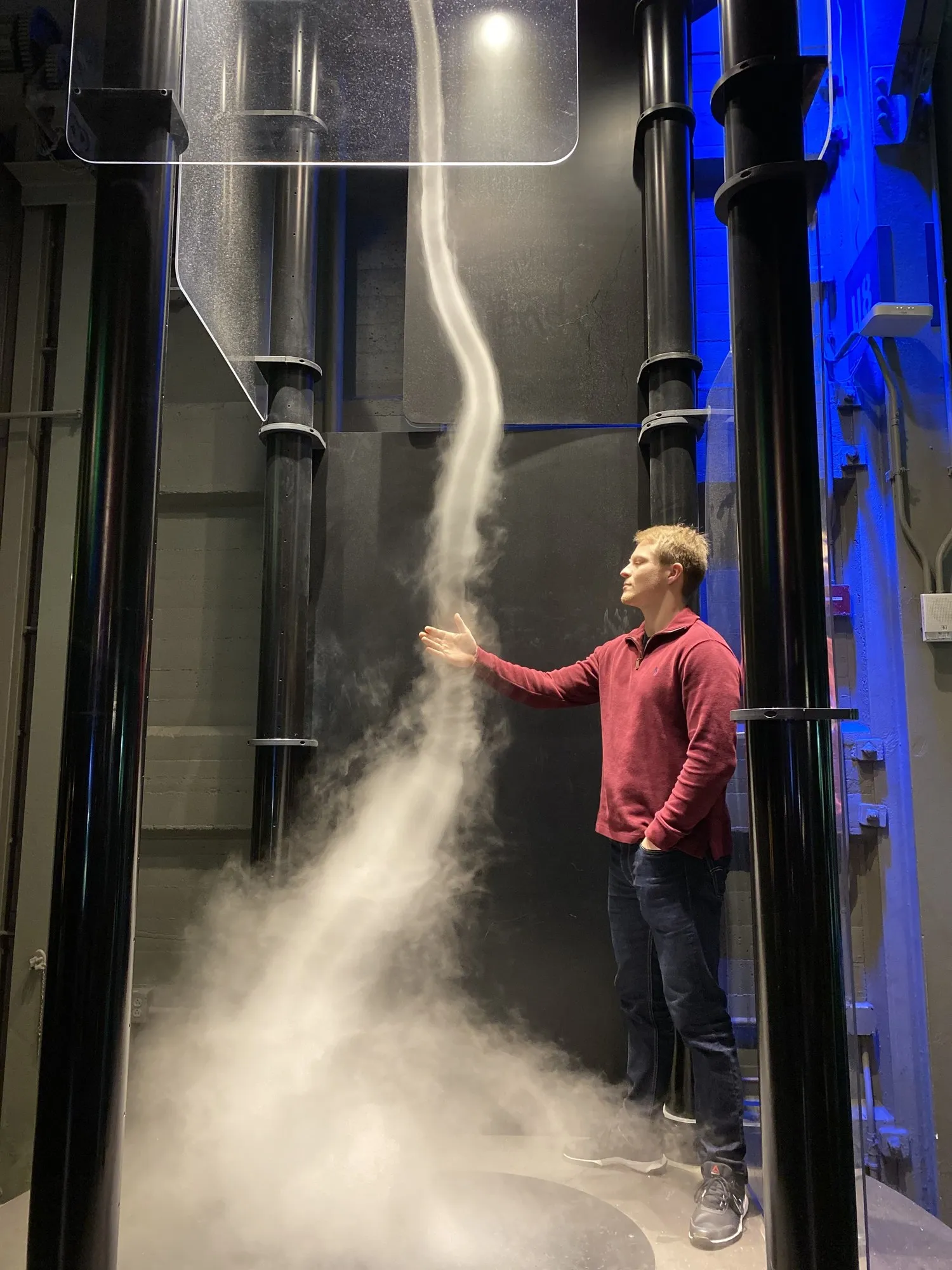 Reaching toward an indoor tornado at the Exploratorium